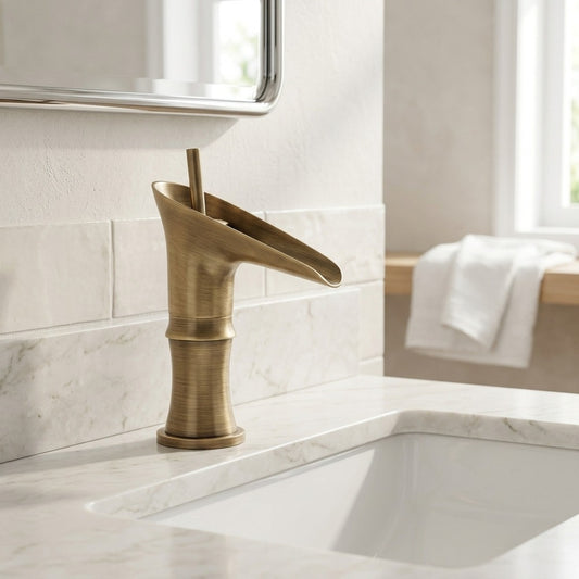 Lagomel waterfall single-hole bathroom faucet in antique brass, set in a Contemporary bathroom