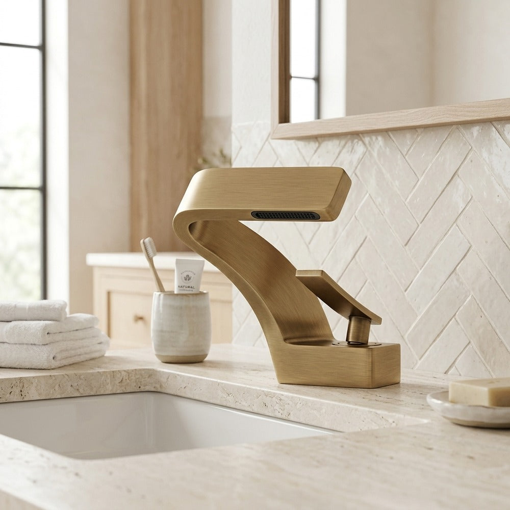 Lagomel waterfall single-hole bathroom faucet in antique brass, set in a Contemporary bathroom