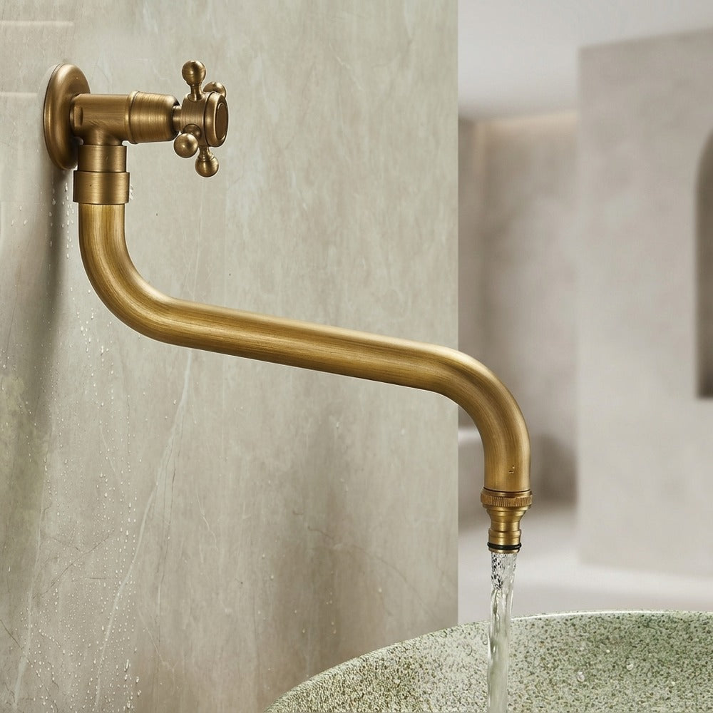 Lagomel wall-mounted single-handle outdoor faucet in antique brass, set in a Vintage/Retro/Traditional/Classic bathroom