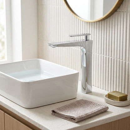 Lagomel single-hole waterfall vessel sink faucet in chrome, two-tone / mixed finish, polished gold, antique brass, set in a Modern bathroom