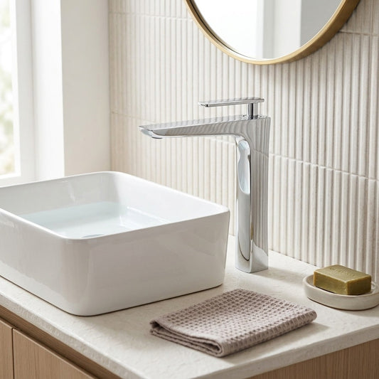 Lagomel single-hole waterfall vessel sink faucet in chrome, two-tone / mixed finish, polished gold, antique brass, set in a Modern bathroom