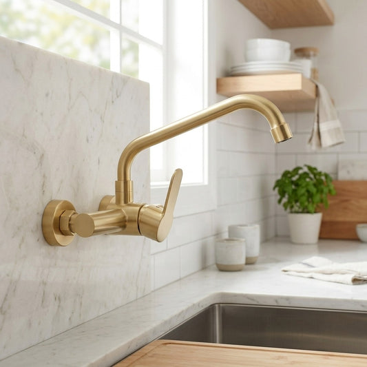 Lagomel single-handle wall-mount kitchen faucet in brushed gold, set in a Modern/Contemporary kitchen