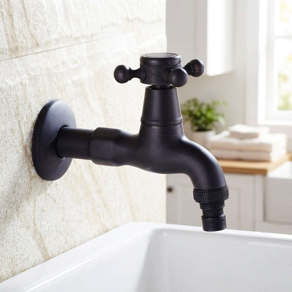 Lagomel wall-mounted outdoor faucet in matte black, antique brass, set in a Vintage/Retro bathroom