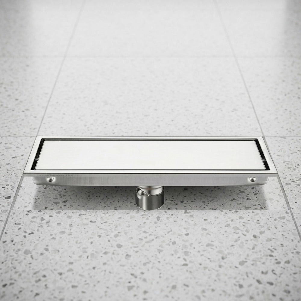 Lagomel linear floor drain in stainless steel, set in a Modern bathroom
