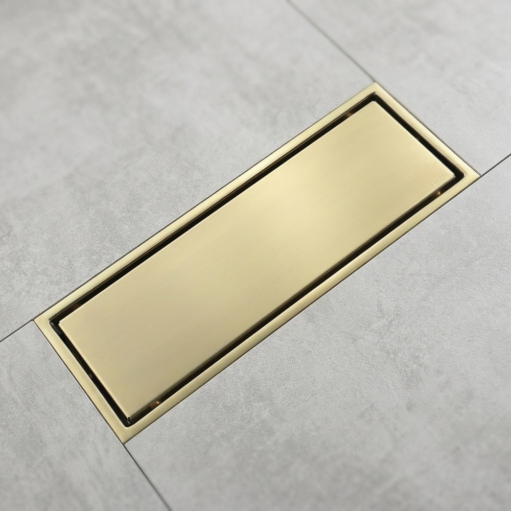 Lagomel linear floor drain in brushed gold, set in a Contemporary/Modern bathroom