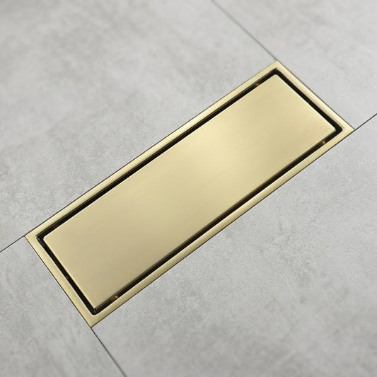 Lagomel linear floor drain in brushed gold, set in a Contemporary/Modern bathroom