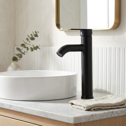 Lagomel single-handle vessel sink faucet in antique brass, matte black, set in a Vintage/Retro/Contemporary bathroom
