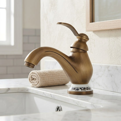 Lagomel single-hole bathroom faucet in antique brass, set in a Traditional/Classic/Vintage/Retro bathroom
