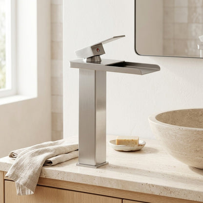 Lagomel waterfall single-handle vessel sink faucet in brushed nickel, set in a Modern bathroom