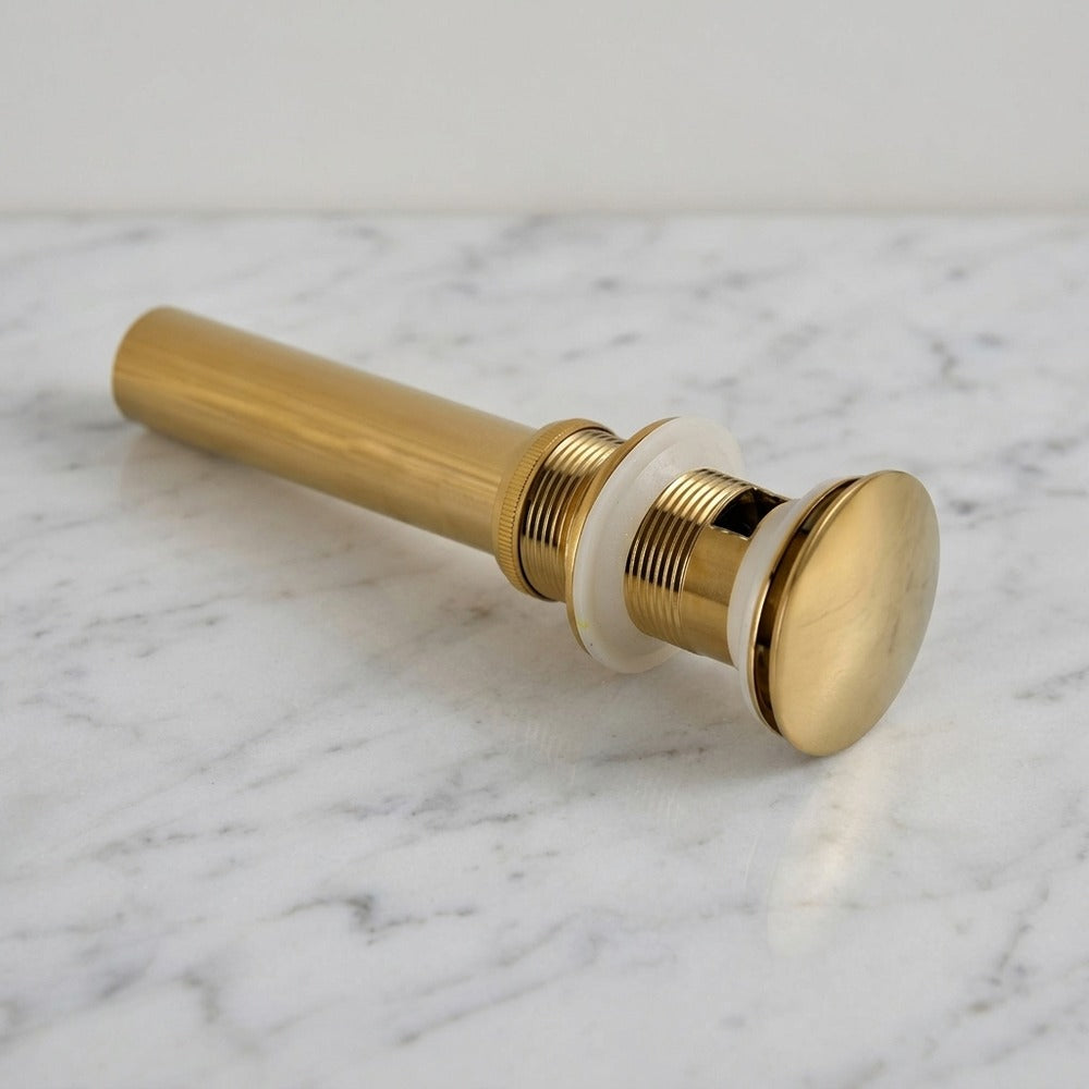 Lagomel bathroom sink drain in polished gold, pvd, set in a Contemporary bathroom