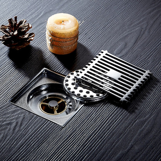 Lagomel square floor drain in antique brass, polished gold, chrome, set in a Modern bathroom